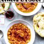 Moroccan chickpea stew, aka Leblebi, on a table with bread and harissa.