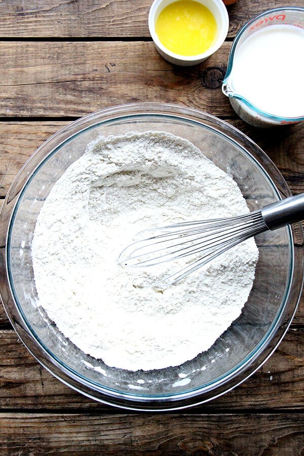A bowl with dry ingredients for Irish soda bread plus a whisk.