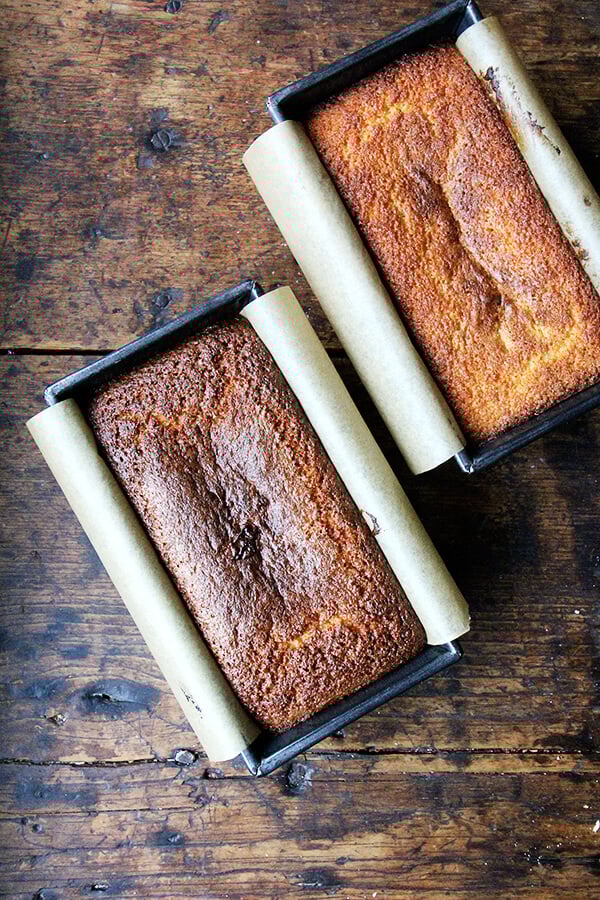 Two loaf pans of freshly baked lemon-semolina cake.