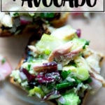 An overhead shot of a smoked trout and avocado salad on toasty bread.