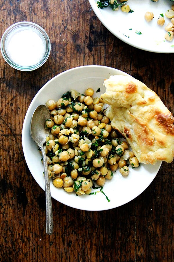 This recipe for chickpea saute with basil and pine nuts is inspired by the beautiful basil that has been arriving in our CSA: sweat garlic in extra-virgin olive oil, add cooked chickpeas, toasted pine nuts, and lots of salt, pepper, and chopped basil; sauté briefly; and serve immediately. Last Friday evening, a few friends came over for dinner, and we ate these chickpeas with grilled whole Branzino, focaccia, and a simple salad — it was a nice summer meal. // alexandracooks.com This recipe for chickpea saute with basil and pine nuts is inspired by the beautiful basil that has been arriving in our CSA: sweat garlic in extra-virgin olive oil, add cooked chickpeas, toasted pine nuts, and lots of salt, pepper, and chopped basil; sauté briefly; and serve immediately. Last Friday evening, a few friends came over for dinner, and we ate these chickpeas with grilled whole Branzino, focaccia, and a simple salad — it was a nice summer meal. // alexandracooks.com