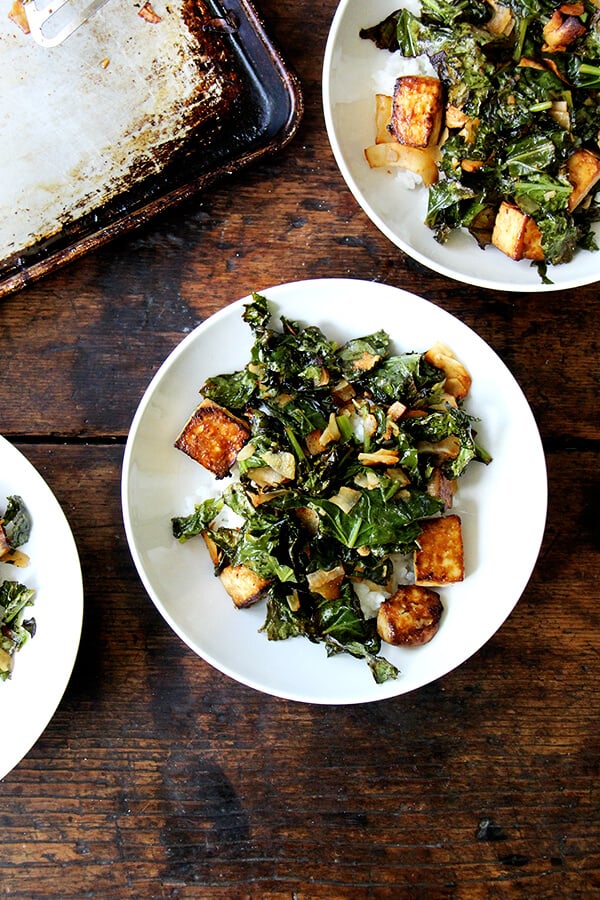 This baked tofu has a simple preparation, which calls for making a four-ingredient dressing, and results in nicely textured and completely tasty tofu—crispy edges, custardy centers, sesame-soy flavor throughout. // alexandracooks.com A bowl of baked coconut kale and tofu.