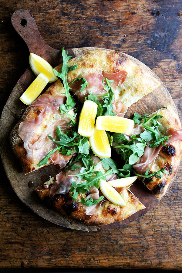 This prosciutto pizza is baked with a smear of crème fraîche and a layer of mozzarella, then topped with prosciutto and arugula out of the oven. It's very simple and very delicious. // alexandracooks.com This prosciutto pizza is baked with a smear of crème fraîche and a layer of mozzarella, then topped with prosciutto and arugula out of the oven. It's very simple and very delicious. // alexandracooks.com
