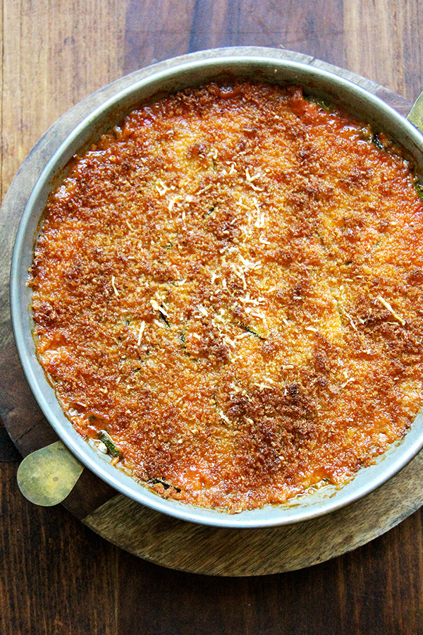 If you're looking for zucchini recipes to help you cull your zucchini crops down, this recipe for zucchini parmesan will fit the bill! Roasting zucchini rounds for 10 minutes, then layering them with homemade sauce and parmesan cheese and finishing it off with a breadcrumb topping. Simple but delicious! // alexandracooks.com zucchini parmesan, just baked