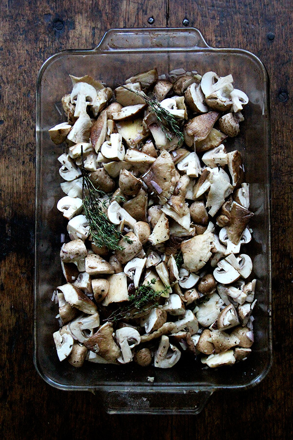 A 9x13-inch pan filled with mushrooms and thyme.