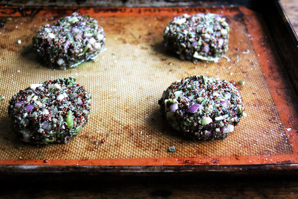 shaped crispy quinoa cakes on a sheet pan