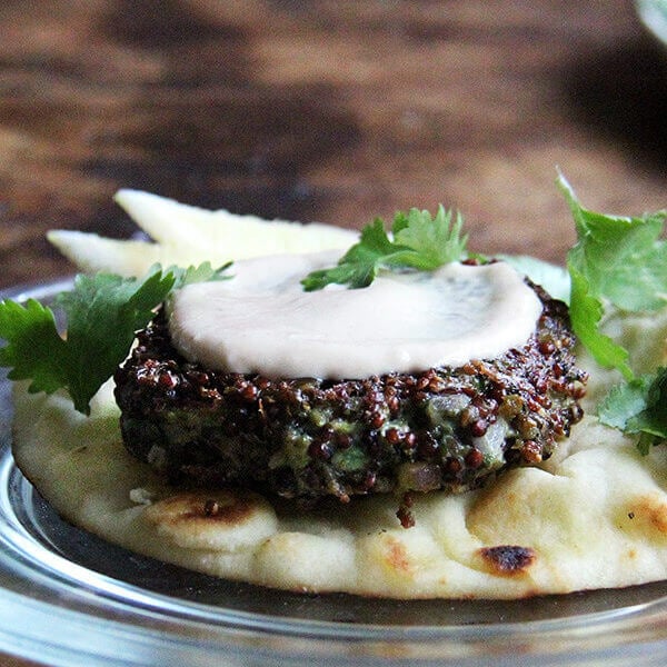 A crispy quinoa cake with tahini sauce.