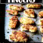 Baked chicken fingers on a sheet pan.