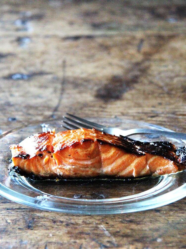 I love this recipe for broiled ginger-soy salmon, which I've made many times over the years. While I've always kept the marinade exactly the same, I've experimented with various cooking methods to avoid having to flip the fish. This method, starting under the broiler and finishing in a hot skillet, is the one I liked best. // alexandracooks.com A plate of ginger-soy salmon.