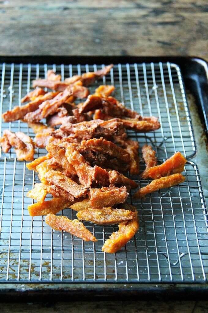 If anything deters you from making these thick-cut sweet potato fries, let it be time, not fear — of fat or the frying process — because these fries, if anything, are less greasy than roasted sweet potatoes wedges, and they are completely irresistible. // alexandracooks.com Just-baked sweet potato fries.