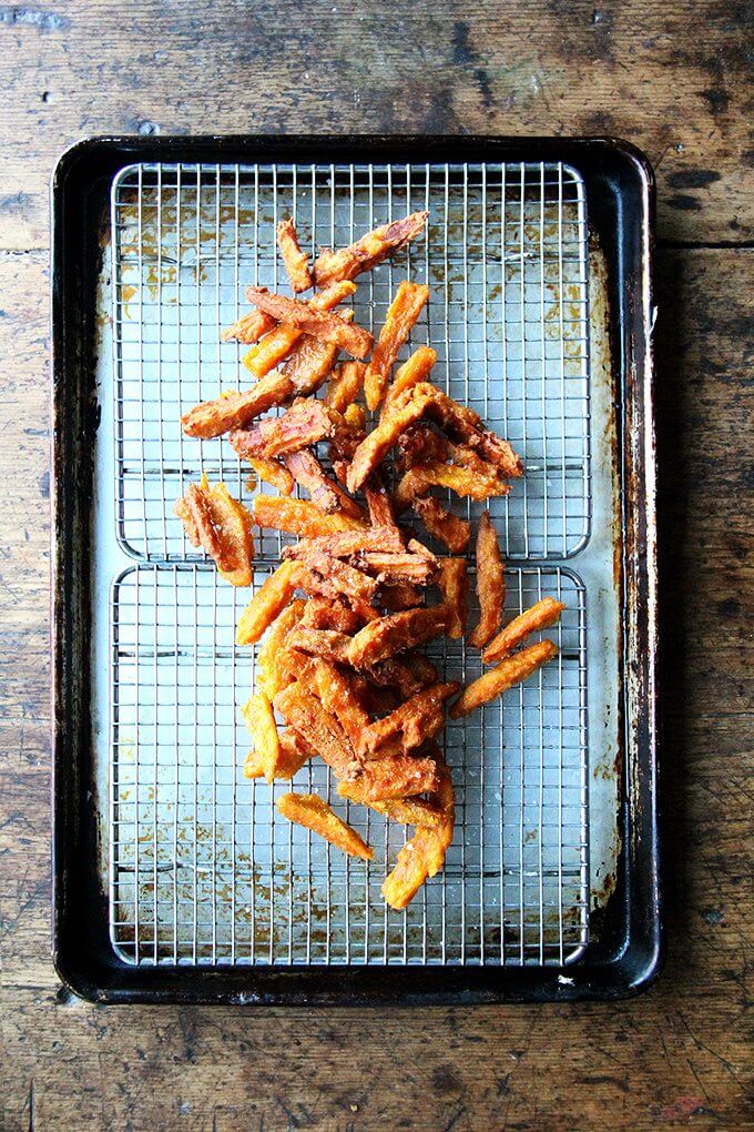 If anything deters you from making these thick-cut sweet potato fries, let it be time, not fear — of fat or the frying process — because these fries, if anything, are less greasy than roasted sweet potatoes wedges, and they are completely irresistible. // alexandracooks.com A tray of just fried thick-cut sweet potato fries.