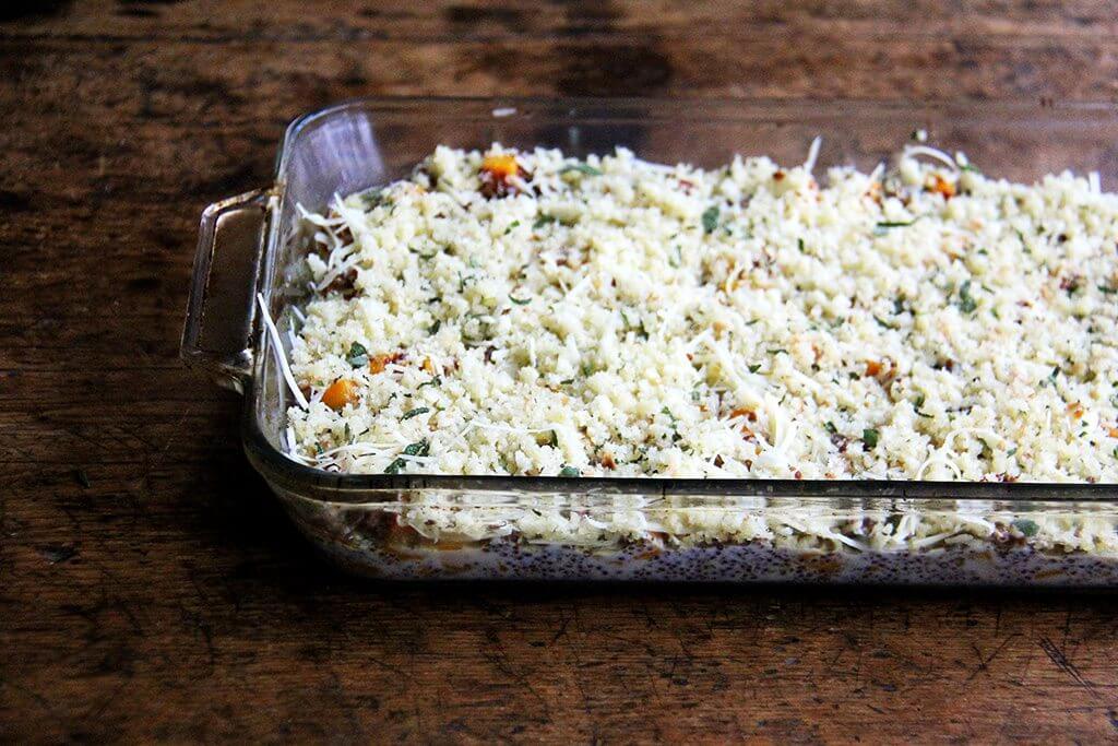 A 9x13-inch pan filled with an unbaked quinoa bake.