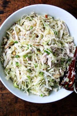 A large bowl of chicken and cabbage salad.