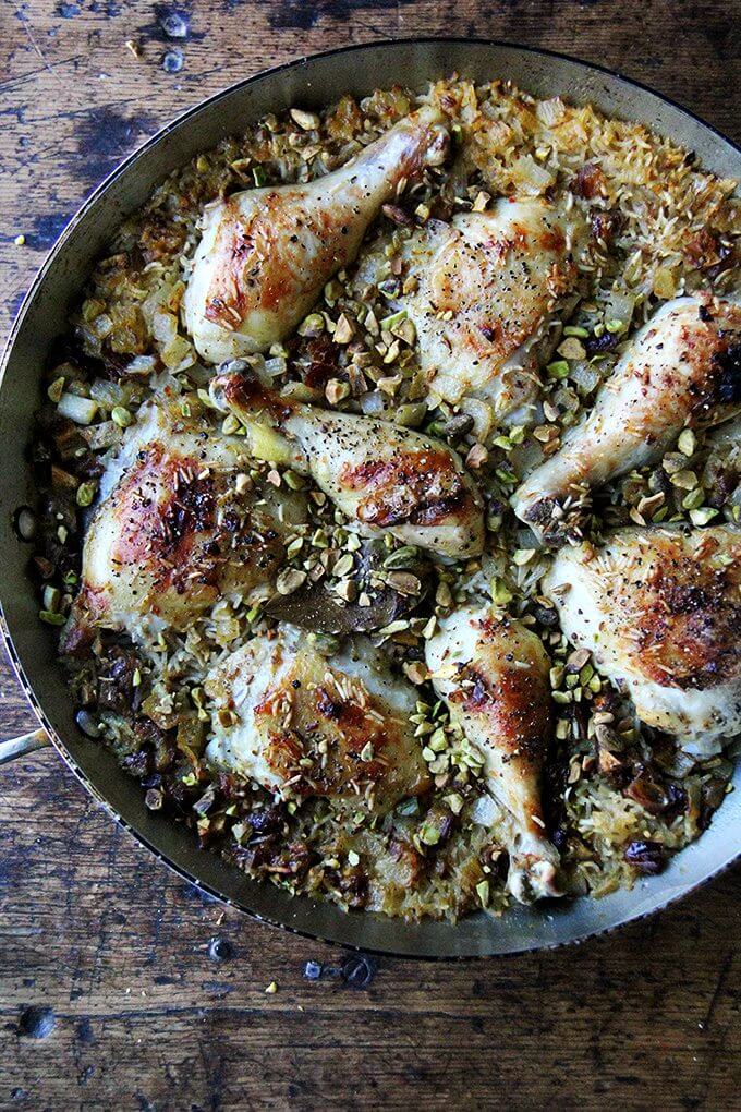 This Moroccan chicken and rice with dates, harissa and pistachios a mix of sweet and spicy, smoky and crunchy, and best of all it couldn't be simpler to prepare. // alexandracooks.com An overhead shot of one-pot Moroccan chicken and rice with dates, harissa, and pistachios.