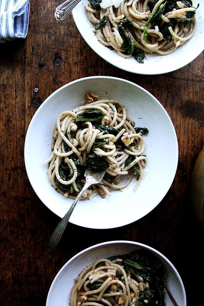 This pasta with spinach, walnuts, and lemon includes fresh greens tossed with a garlicky, white wine sauce made slightly creamy with crème fraîche. Yum. // alexandracooks.com This pasta with spinach, walnuts, and lemon includes fresh greens tossed with a garlicky, white wine sauce made slightly creamy with crème fraîche. Yum. // alexandracooks.com