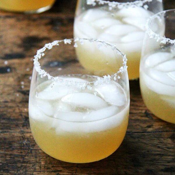 A glass of margarita with a salted rim.