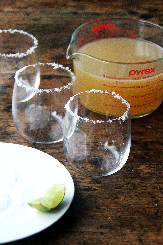 Salted margarita glasses on a table.