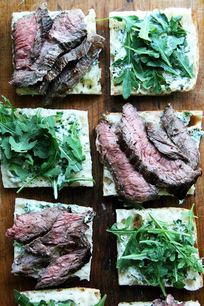In these skirt steak sandwiches, skirt steak, which cooks to medium-rare in just about 5 minutes, is layered with arugula between slices of focaccia smeared with herbed mayonnaise. The key, as with all meats, is to let the steak rest for at least 10 minutes before slicing, and with skirt steak, to slice it thinly against the grain. // alexandracooks.com In these skirt steak sandwiches, skirt steak, which cooks to medium-rare in just about 5 minutes, is layered with arugula between slices of focaccia smeared with herbed mayonnaise. The key, as with all meats, is to let the steak rest for at least 10 minutes before slicing, and with skirt steak, to slice it thinly against the grain. // alexandracooks.com