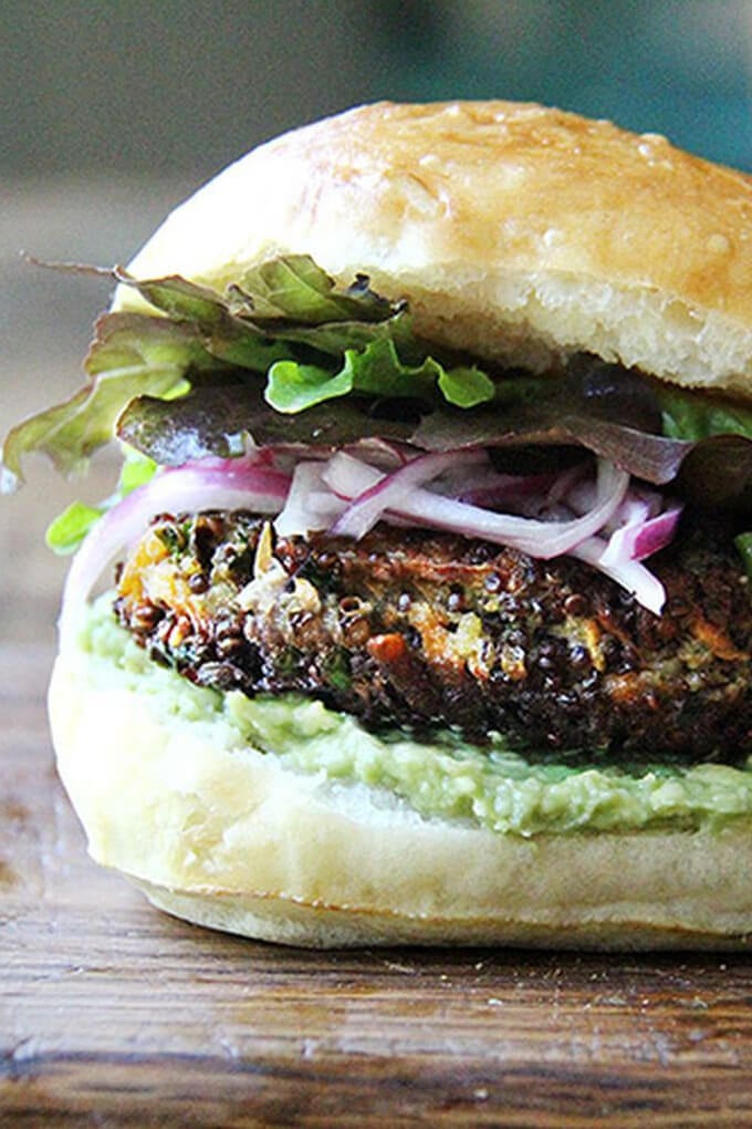 A sweet potato and mushroom quinoa burger on a plate.