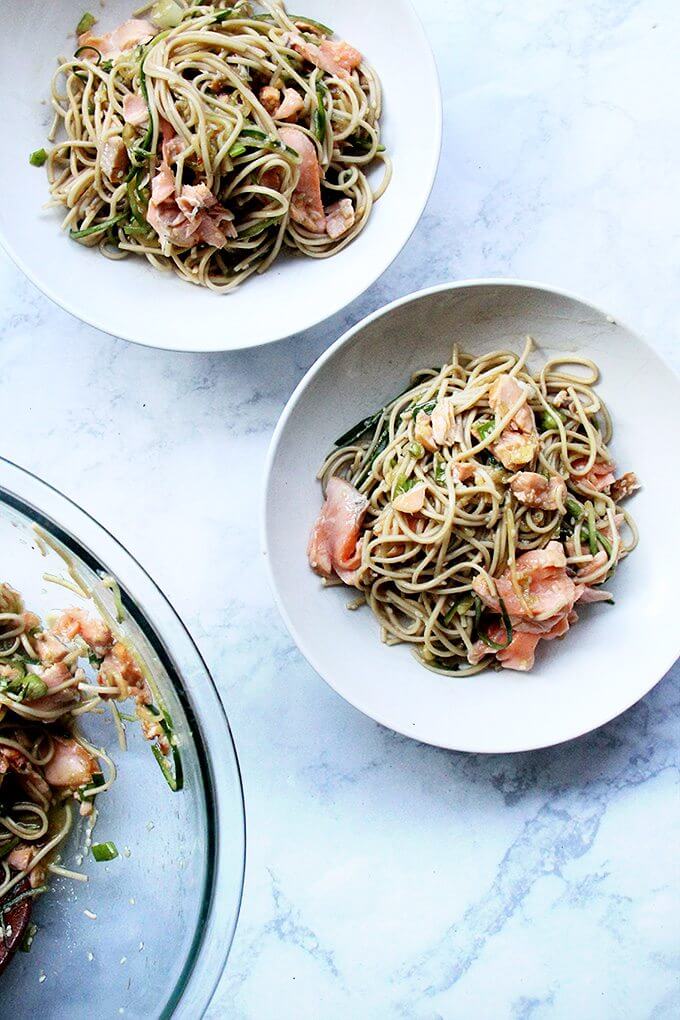 One sauce, two roles—a revelation! With dinner prep (and clean up) decreased by half, this recipe for ginger-sesame soba noodles with cedar plank salmon slips into weeknight-friendly territory, requiring about 30 minutes of work. // alexandracooks.com Bowls of ginger-sesame soba with salmon.