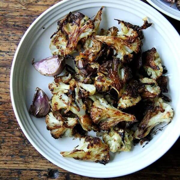 A plate of oven-roasted cauliflower florets with parmesan.