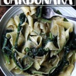 A bowl holding no-bacon carbonara loaded with greens.