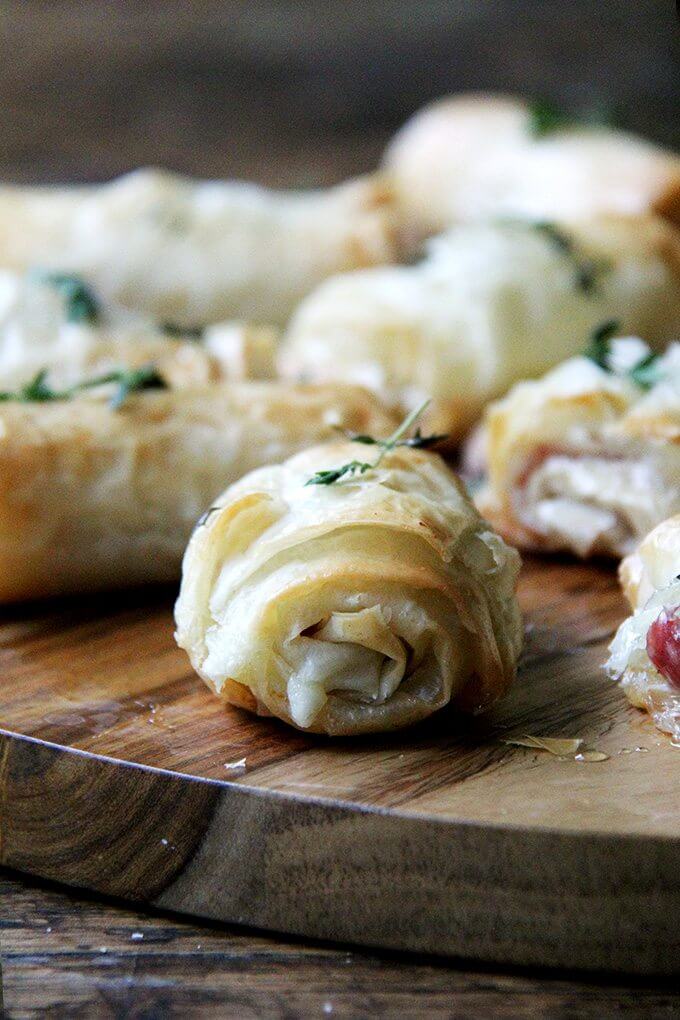 Hit with a drizzle of honey out of the oven, these salty-sweet, flaky salami and provolone phyllo rolls are irresistible. You can also assemble them ahead of time and stash them in the fridge or freezer until needed. // alexandracooks.com An up close shot of a salami and provolone phyllo roll.