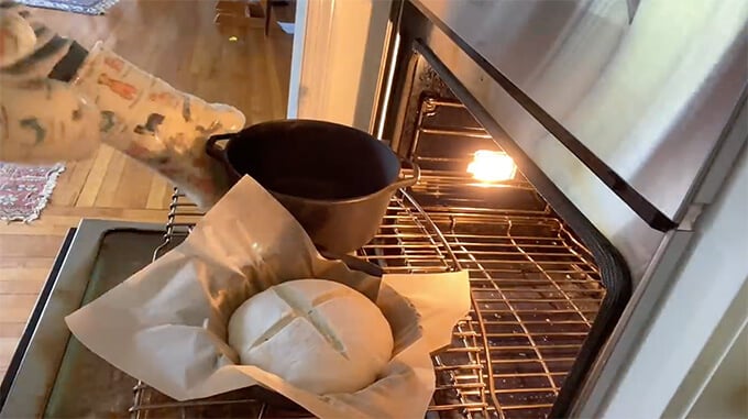 A loaf of sourdough bread in the oven. 