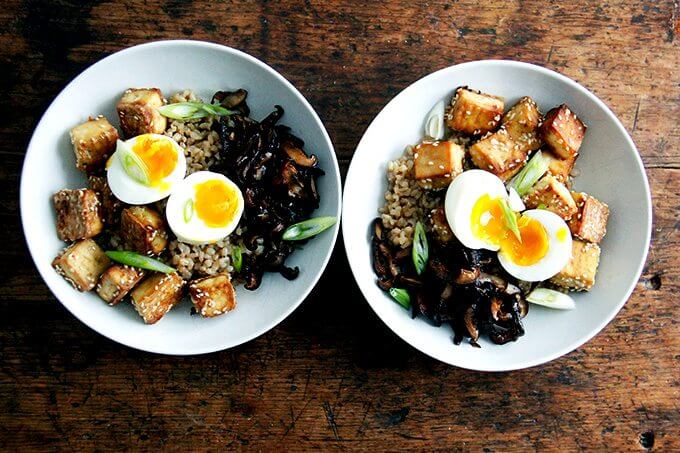 Two bowls of perfectly cooked Instant Pot brown rice topped with soft-boiled eggs.