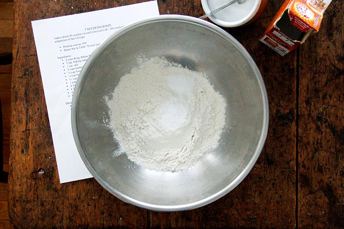 Dry ingredients for three seed crackers in a mixing bowl.