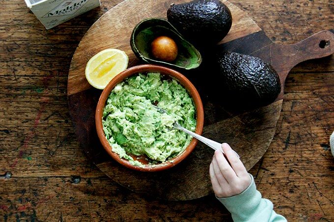 mashed avocado with lemon and salt in a bowl.