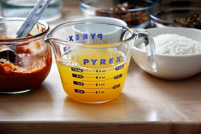 A liquid measure with fresh orange juice and water.