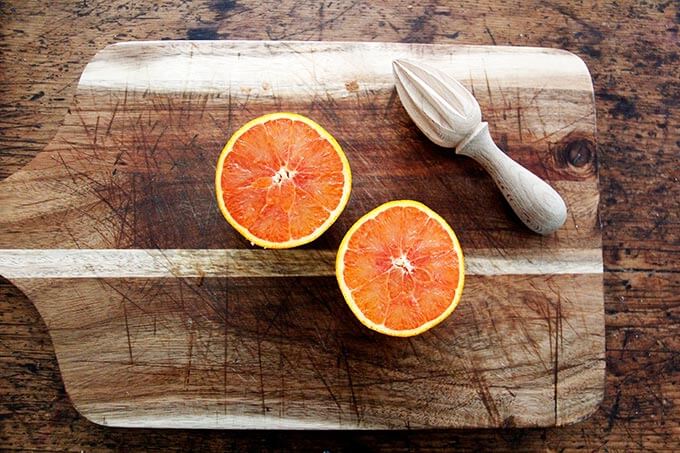 A halved orange on a board.