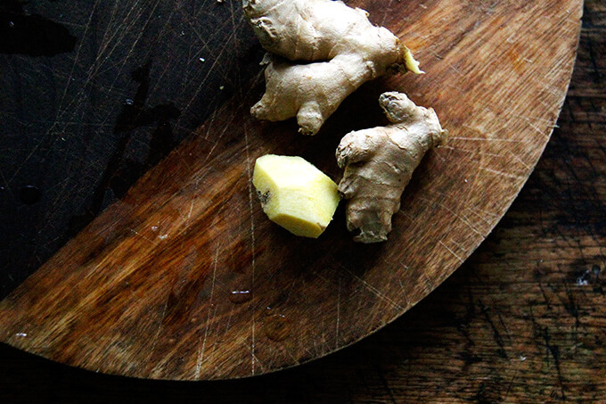 A board of fresh ginger, peeled.