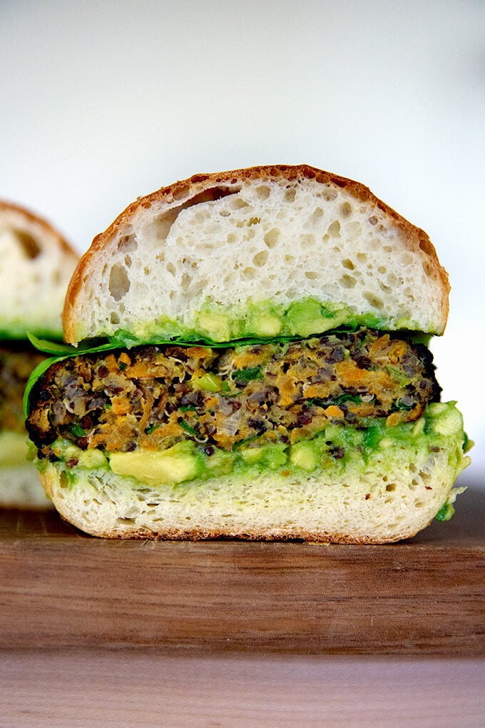 Halved Sweet potato and quinoa veggie burger.