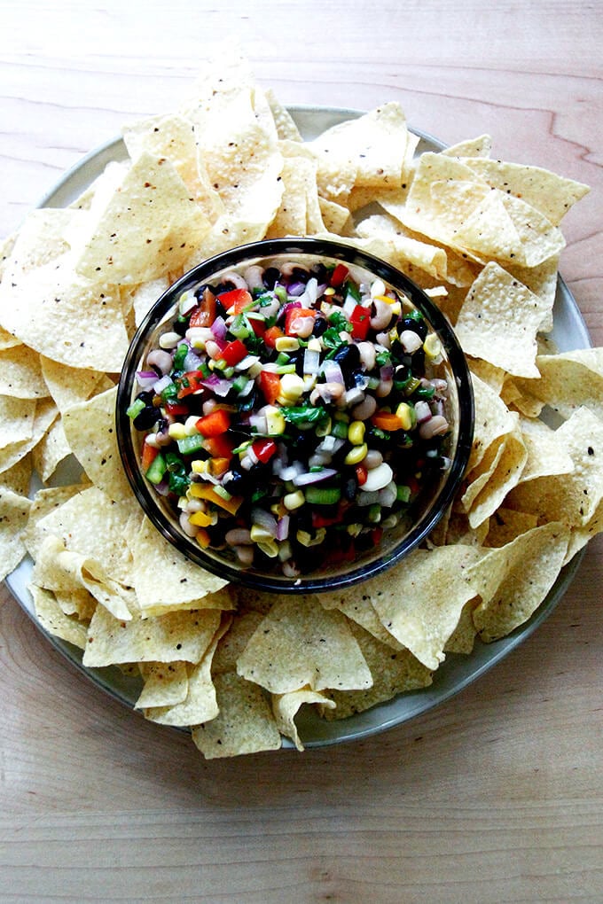 A bowl of Texas Caviar aside tortilla chips.
