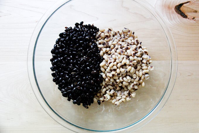 A bowl with cooked black beans and black eyed peas.