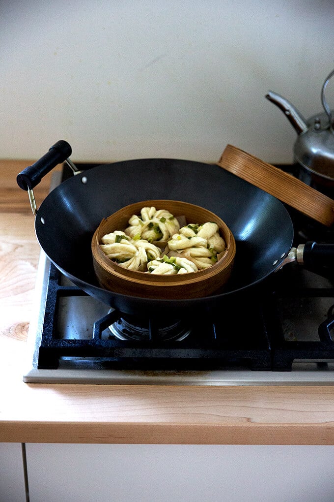 A wok with a steamer basket fitted inside.