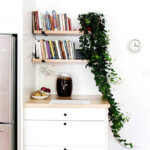 A photo of a remodeled kitchen with open shelves and butcher block countertops.