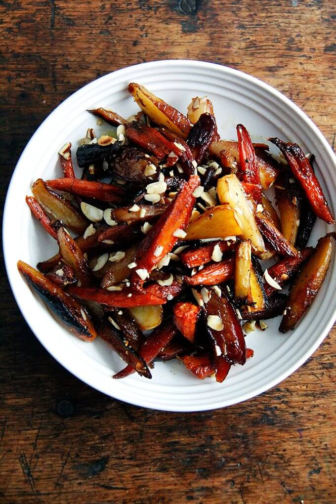 A bowl of twice-roasted carrots with honey and almonds.