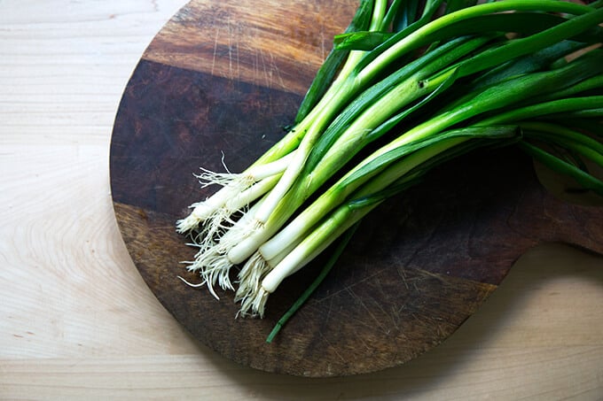 A board with scallions on top.