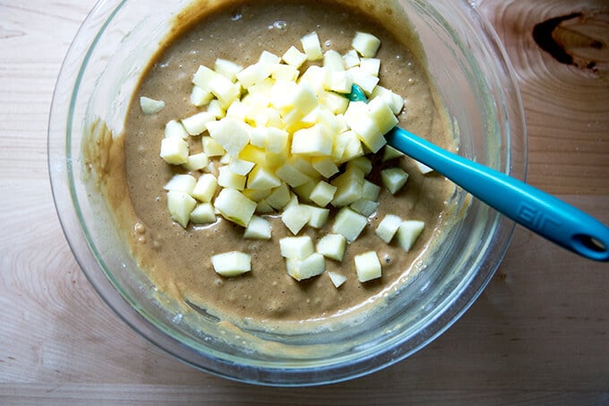 Adding chopped apples to batter.