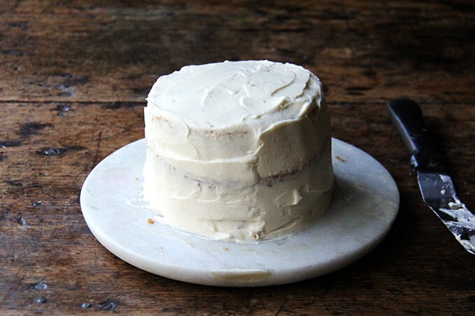 A frosted 4-layer one-bowl buttermilk birthday cake on a cake platter.