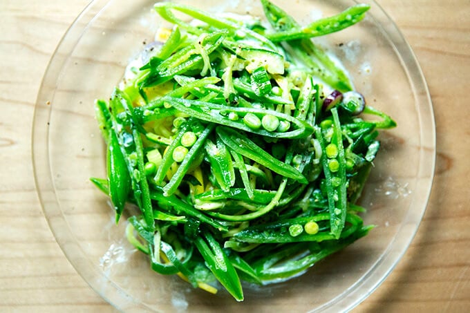 A plate of sugar snap pea salad with buttermilk dressing.
