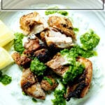 A bowl of smoky grilled chicken with tzatziki and skhug.