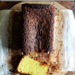 A lemon semolina cake on a board, sliced.