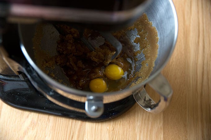 A stand mixer with butter, brown sugar, vanilla, and eggs.