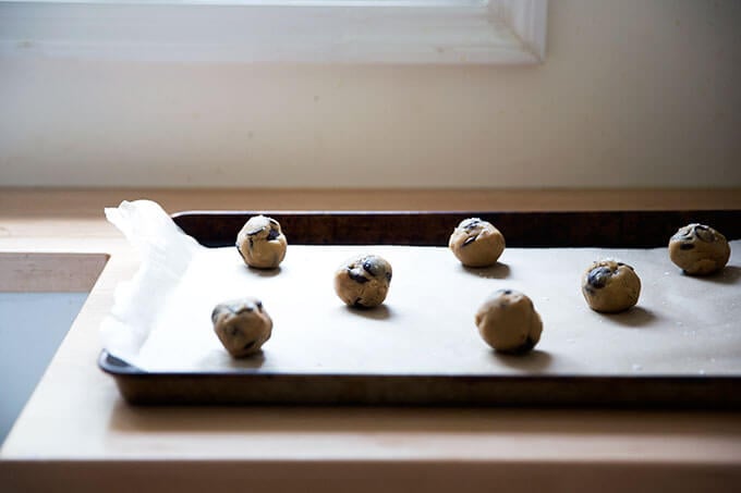 Gluten-free cookie dough balls on a sheet pan.