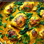 A pot of one-pan Thai chicken curry with spinach.