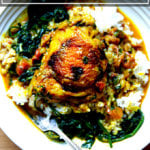 A bowl of one-pan Thai chicken curry with rice and spinach.